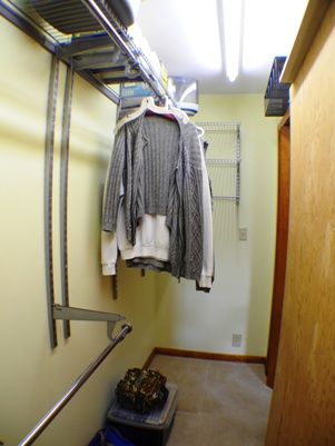 Wall-to-wall storage room hidden behind bookcases in family room